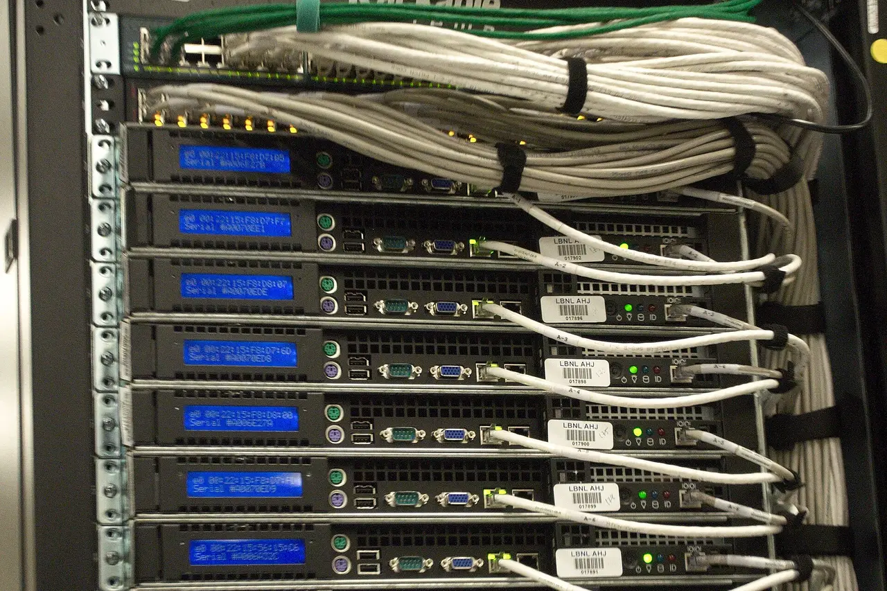 The back of a rack of servers, with bundled cables running across them