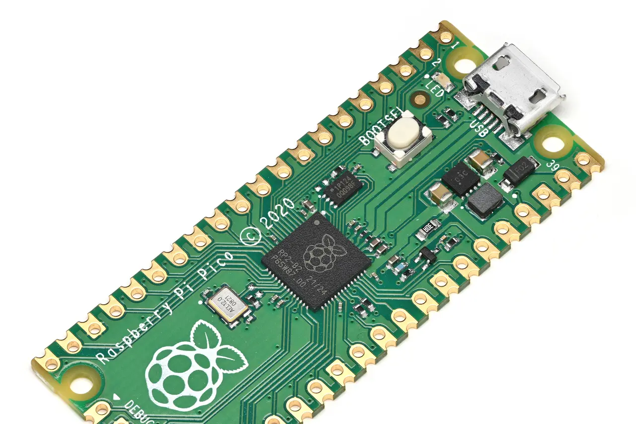 A green Raspberry Pi Pico microcontroller board seen at an angle