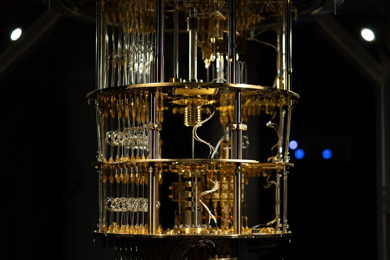 The gold-coloured inner structure of a quantum computer, hanging in a dark room